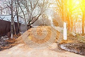 Big pile of sand on a footpath. Workers flooded the passage. Problems are not high-quality road repairs. Destroyed the pedestrian