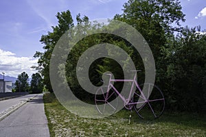 Big pink bicycle at Ponte nelle Alpi, Italy photo