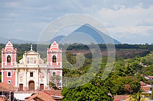 Big Pink Church Standing in front of a Mountain