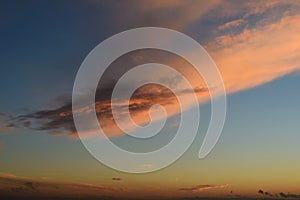 Big pink cloud on blue sky.