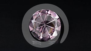 Big pink rhinestone, diamond, crystal sparkles on black background. Zoom.