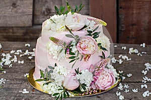 Big pink wedding cake decorated by flowers