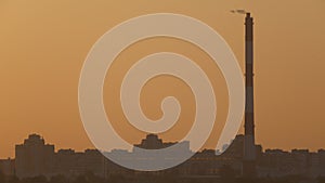 Big pipe on city skyline at sunset - industry view