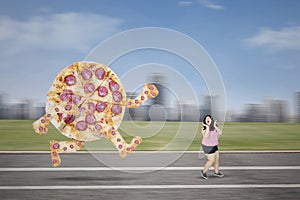Big pizza chasing obese woman on the track