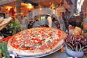 Big pizza displayed in restaurant window in Venice, Italy.