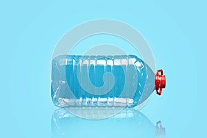 Big plastic bottle on a blue background.Reflection. Products, packaging, storage, recycling