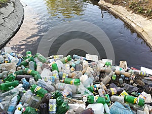 Water pollution, plastic bottles and garbage on river surface