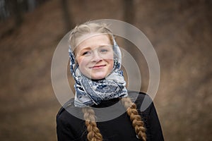 Big portrait of beautiful red-haired girl in scarf