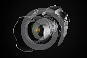 Big professional DSLR camera on black background