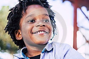 Big real smile from young happy black afro boy - playful kids have fun - joyful african boy concept - dreadlocks children smile photo