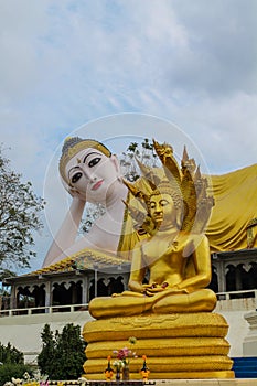 Big reclining Buddha statue and Gold Buddha with naga in Thailand Wat