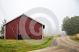 A big red agricultural building, a quiet crossing of two village roads