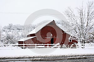 Big red barn in the snow.