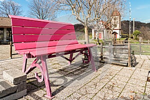 The Big red bench on the hill overlooking the Gattinara town, in the province of Vercelli, Italy