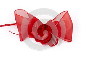 A big red bow / ribbon isolated on white background. Present packing, gifting, valentine`s day decoration or xmas gift concept
