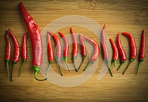 A big Red chilli pepper in small Red chilli pepper on chopping block