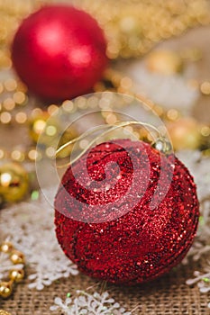 Big red Christmas ball on the background of decorations close up