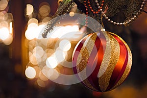 Big red gold ball in the foreground. Christmas background, Christmas decorations and garlands