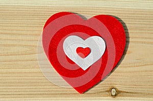 Big red heart of soft fabric, on wooden background. family, Valentine Day, Wedding Love Concept. photo