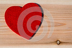 Big red heart of soft fabric, on wooden background. Valentine Day, Wedding Love Concept. photo
