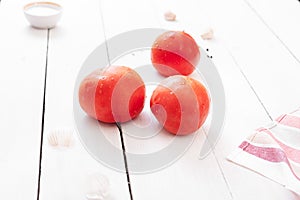 Big red ripe tomatoes on the kitchen table