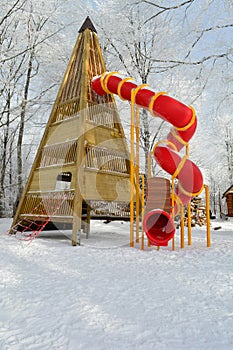 Big red toboggan on snowy playground