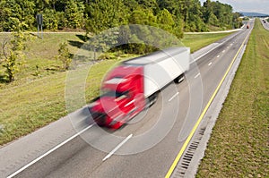 Big Red Truck Speeding Down Highway photo