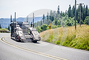 Big rig car hauler semi truck running on the road with empty semi trailer to point of loading