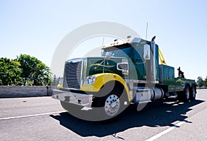 Big rig equipped towing semi truck on road