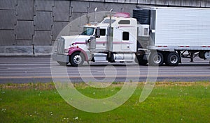 Big rig semi truck custom built with reefer trailer unit on road