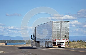 Big rig semi-truck with reefer semi trailer transporting cargo o