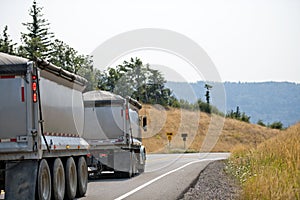 Big rig semi truck tipper with two trailers driving with bulk ca