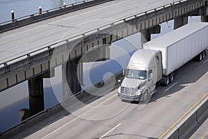 Big rig semi truck tractor transporting cargo in semi trailer ru photo