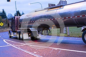 Big rig semi truck transporting liquid in tank semi trailer turn