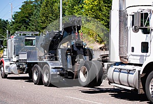 Big rig towing semi truck tow ather semi truck tractor on the road photo