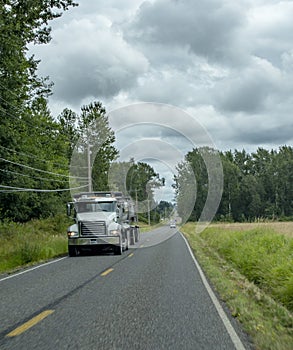 Big rig truck hauling along country road