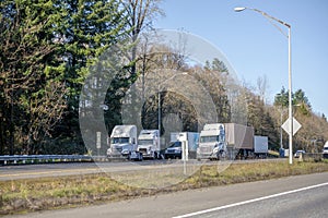 Big rigs semi trucks standing on rest area on the side of the road