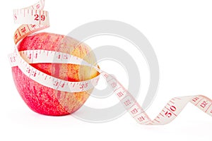 Big ripe red apple with measure tape