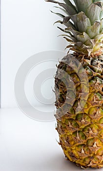 Big ripe yellow pineapple with green leaves close up closeup. Summer tropical fruits. Ananas fruit.