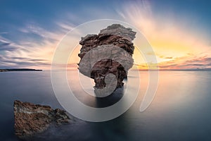 Big rock on the sea at sunset photo