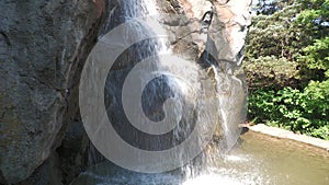 Big rock with water cascading from the top