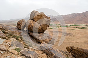 Big rocks on the edge of a mountain in the desert