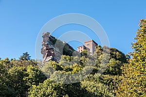 Big rocks, old castle and high tower made of sandstone