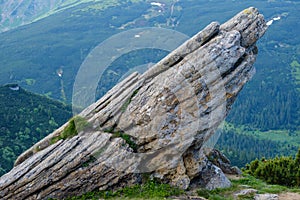 Big rocky boulder on summer mountain