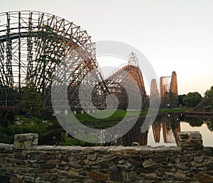 Big roller coaster in an amusement Park. High- speed ride on the rails at sunset.