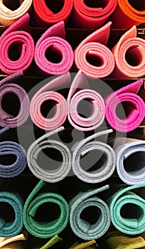 big rolls of fabric in the shelf of the tailoring