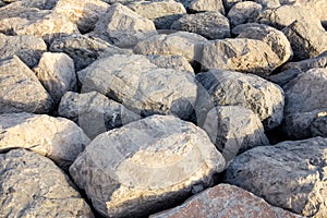 Big rough stones and rocks texture background, forming a pier in Dubai