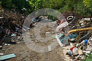 Big rubbish dump neare the road, nature and blue sky background