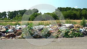 Big rubbish dump neare the road, nature and blue sky background