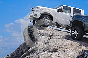 Big rugged trucks on a rocky ledge